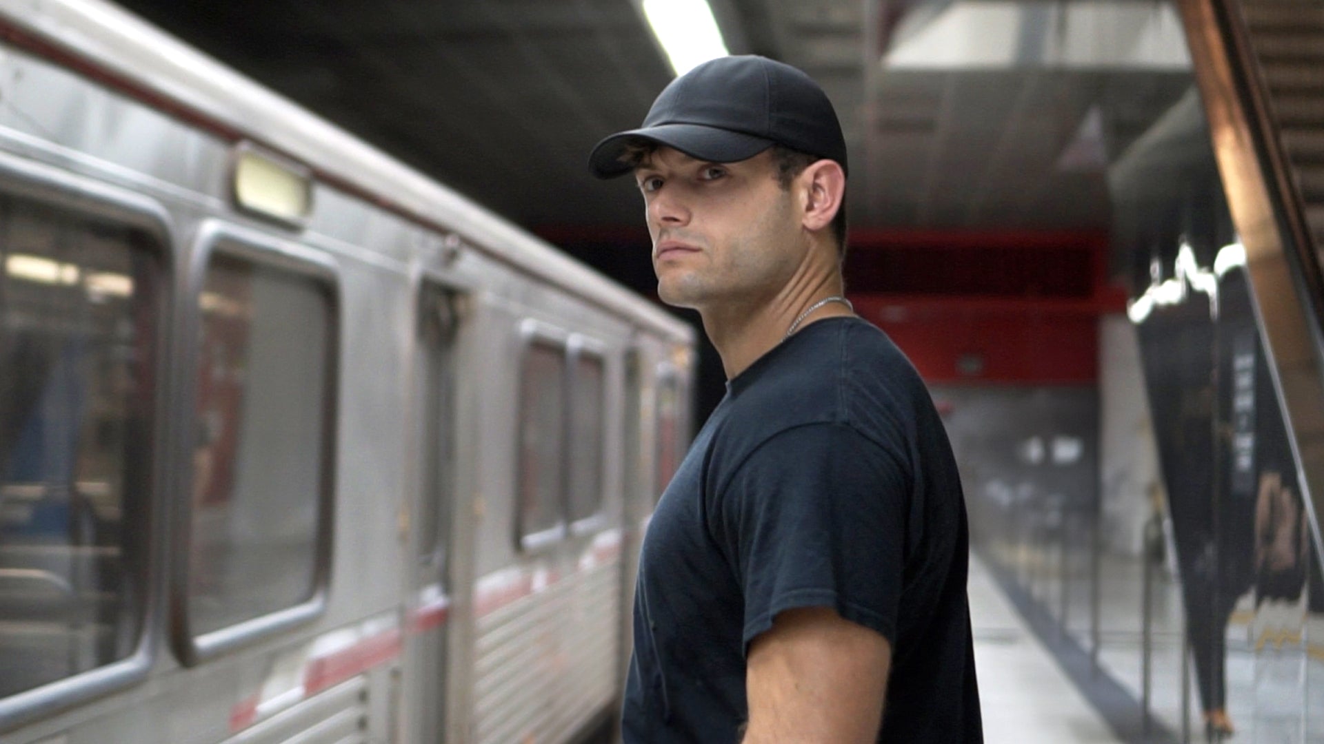 Man wearing STLTH Tech Cap in subway